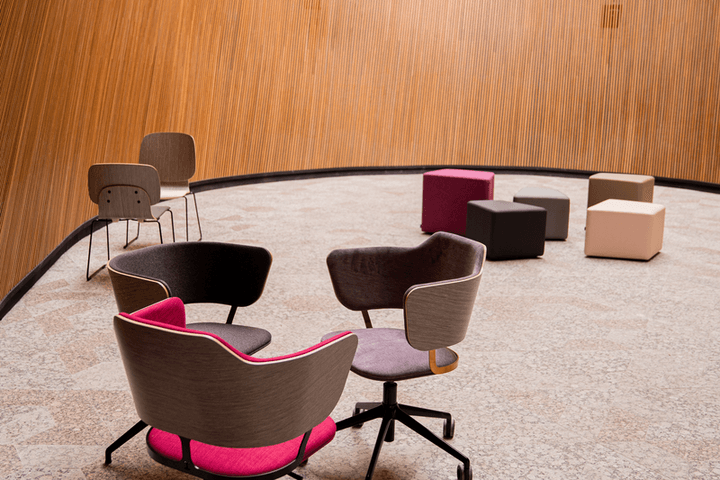 Circular meeting chairs in a wood-panelled room